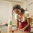happy woman with rolling pin cooking at home