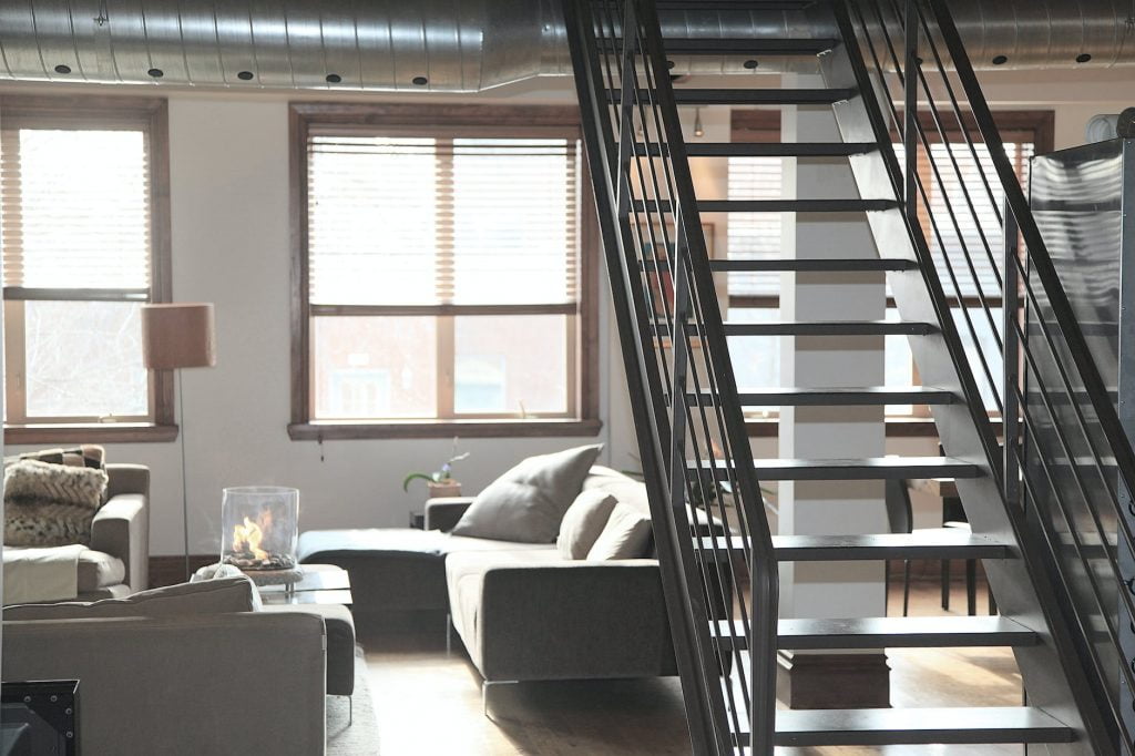 gray couch beside window