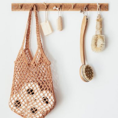 body brushes and toiletries on wooden hanger
