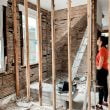 woman standing in room with unfinished walls