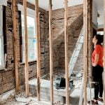 woman standing in room with unfinished walls